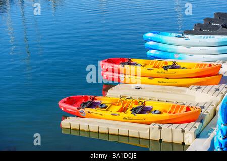 Oceanside, Kalifornien - 27. Dezember 2024: Leuchtend gelbe und rote Kajaks reihten an einem sonnigen Tag am Dock in Oceanside, Kalifornien. Stockfoto