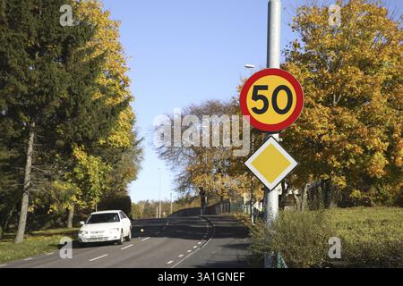 Weißes Auto auf der Straße auch Schild Geschwindigkeitsbegrenzung 50, Skepplanda, Schweden, Skandinavien, Europa Stockfoto
