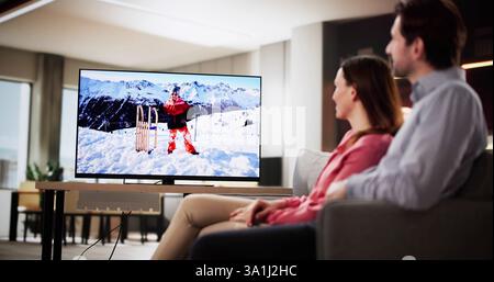 Entspanntes Paar, das einen Filmabend in einem gemütlichen Wohnzimmer zu Hause genießt. Stockfoto