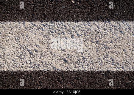 Abstrakte Textur einer Asphaltstraße mit weißer Farbe Stockfoto