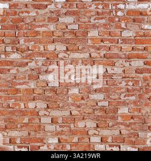 Alte rote Ziegelwand, die Abnutzung und Verschleiß durch Witterung zeigt Stockfoto