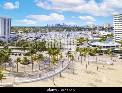Luftbild des Fort Lauderdale Beach Park mit goldenem Sand, palmengesäumter Promenade, einem Yachthafen voller Yachten und modernen Hochhäusern Stockfoto