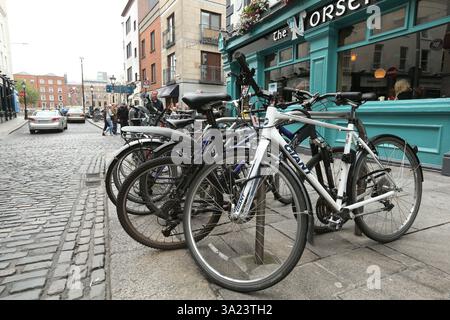 Dublin, Irland - 25. Juni 2014 - Fahrräder, die an Fahrradschienen vor dem Norseman Pub in Temple Bar befestigt sind Stockfoto