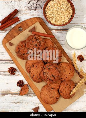 Hausgemachte Schokoladenchips und Nüsse glutenfreie Haferbrei-Kekse mit Ohren auf hölzernem Hintergrund, moderne Bäckerei und Getreidekost-Konzept. Gesundes Frühstück mit Stockfoto
