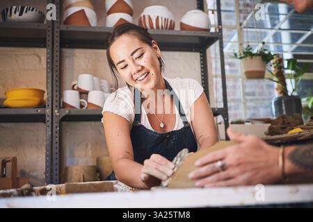 Leute, Team und Töpferunterricht im Studio, arbeiten zusammen und schnitzen Ton für keramisches Handwerk. Unterricht, Ausrüstung und Hilfe beim Unterricht an Stockfoto