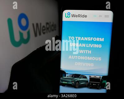 Deutschland. Januar 2025. In dieser Fotoabbildung hält eine Person ein Mobiltelefon mit der Webseite des chinesischen Autonome Fahrers WeRide Inc. Auf dem Bildschirm mit Logo. Quelle: SOPA Images Limited/Alamy Live News Stockfoto
