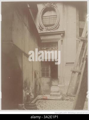 Eine detaillierte Fotografie von Eugène Atget vom Innenhof des Hôtel Colbert in Paris, die die architektonischen Merkmale und das Ambiente des Raumes im August 1899 zeigt. Stockfoto