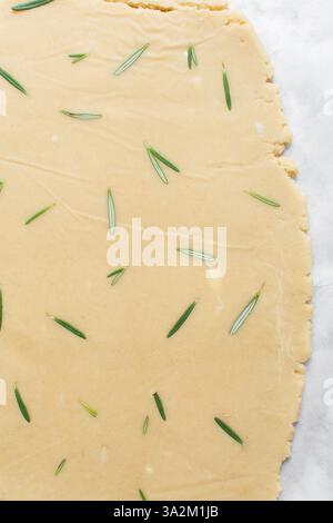 Draufsicht auf ausgerollten Rosmarinzucker-Keksenteig, Prozess der Herstellung von ausgeschnittenen Zuckerkeksen Stockfoto