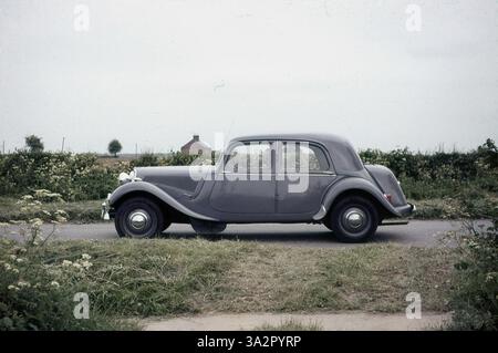 1960er Jahre, historische Seitenansicht einer stilvollen französischen Limousine, einer Citroen Traction Avant, auf einer Landspur geparkt, England, Großbritannien. Der in den frühen 1930er Jahren entwickelte Traction Avant – französisch für Frontantrieb – war ein innovatives Fahrzeug, das zum ersten Mal in Serienfertigung einen Frontantrieb hatte, eine Monocoque-Karosserie, also ohne separate Chasis und Allround-Einzelradaufhängung. Erstmals 1934 produziert, gab es mehrere Modelle und Varianten des Originalwagens. Hier sehen Sie die größere „normale“ Version aus den 1950er Jahren, die länger ist, mit einem größeren Motor und einem vergrößerten Kofferraum, der in Großbritannien als „Big 15“ bekannt ist. Stockfoto