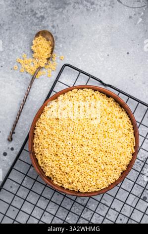 Rohe stelline Nudeln, ungekochte italienische Suppe Nudeln in einer Schüssel. Grauer Hintergrund. Draufsicht. Stockfoto