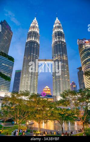 Kuala Lumpur, Malaysia - 27. Dezember 2019: Malerischer Abendblick auf die Petronas Towers vom KLCC Park aus mit einem farbenfrohen Sonnenuntergang. Stockfoto