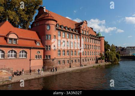 STRASSBURG, FRANKREICH - 19. SEPTEMBER 2024: Schulgebäude an einem Kanal in Straßburg, Frankreich Stockfoto