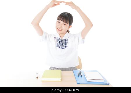 Schulmädchen in Uniform, das die Malu zeigt Stockfoto