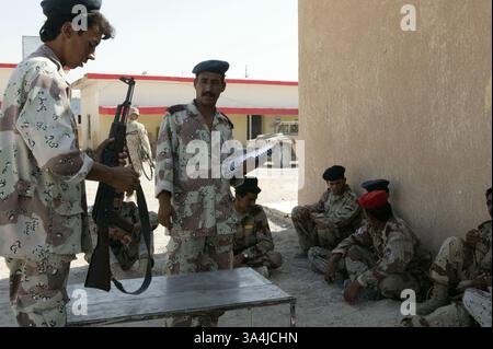 1. August 2004; Camp Delta, Irak; Ein Soldat mit Kompanie D, 505. Bataillon, irakische Nationalgarde, nimmt an der Reihe, um ein AK-47-Gewehr während des Waffentrainings in Camp Delta zu montieren und zu zerlegen. Das Lager wird von Marines der Weapons Company, des 3. Bataillons, des 1. Marineregiments und irakischer Soldaten als Teil eines kombinierten Aktionsprogramms bemannt, in dem beide Streitkräfte zusammen leben und trainieren. Stockfoto