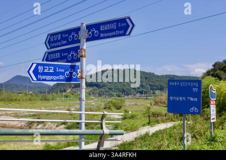 Damyang County, Südkorea - 23. September 2020: Blaue Radwegschilder markieren die Entfernungen zur Metasequoia Road, Damyang Dam und Hyanggyogyo Bridge alo Stockfoto