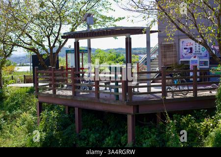Damyang County, Südkorea - 24. September 2020: Ein hölzerner Rastplatz mit Bänken und Fahrradständern im Damyang Dam Certification Center stellt c Stockfoto
