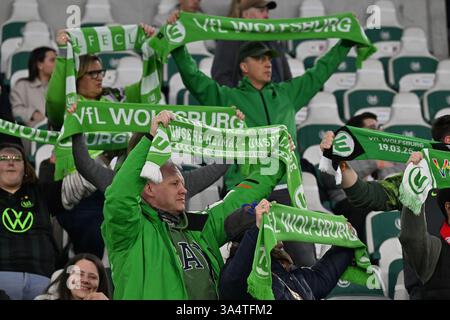 Wolfsburg, Deutschland. März 2025. Fußball, Frauen: Champions League, VfL Wolfsburg - FC Barcelona, K.-o.-Runde, Viertelfinale, erstes Leg, Volkswagen Arena. Fans des VfL Wolfsburg stehen mit ihren Tüchern auf den Ständen. Quelle: Swen Pförtner/dpa/Alamy Live News Stockfoto