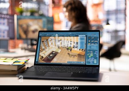 Der Architekturdesigner arbeitet an einem Projekt für das Design eines digitalen Wohnraums und verwendet ein 3D-Modellierungsprogramm, um Möbel zu arrangieren. Die Software mit erweiterter Benutzeroberfläche für professionelles Rendering. Stockfoto