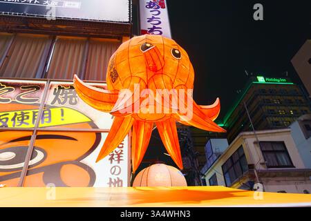 Osaka, Japan - 22. September 2024, Panoramablick auf das asiatische Restaurantschild mit Papierskulptur des Oktopus, im Bezirk Dotonbori, nachts, mit Illu Stockfoto