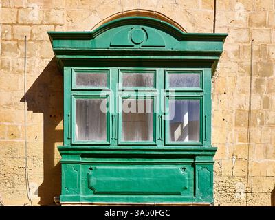 Altes grünes Holzfenster an der Wand eines alten Hauses in Malta Stockfoto