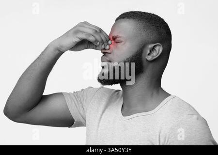 Jungen afro Mann Probleme mit Vision, die Nase und die Augen reibt, Schwarz und Weiß Stockfoto