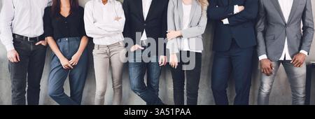 Nicht erkennbares Geschäftsteam posiert für einen Gruppenfoto während einer Pause in einem modernen Büro. Diese vielfältige Szene mit Kollegen vermittelt Teamarbeit, Partnerschaft und Unternehmenskultur. Ideal für Unternehmen und Teambuilding-Marketingmaterialien. Stockfoto