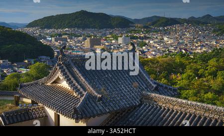 Himeji, Japan - 24. September 2024, Panoramablick auf das Dach mit Fliesen von Himeji Castle, White Reion Castle, Himeji Town und Bäumen auf bac Stockfoto