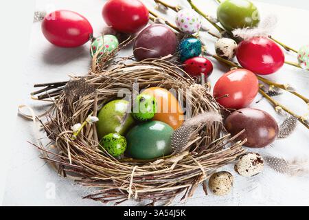 Bunte Ostereier im Vogelnest. Frohe Ostern. Draufsicht. Stockfoto