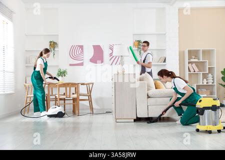 Professionelles Reinigungsteam, das im Zimmer arbeitet Stockfoto