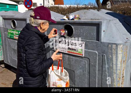 Eine Frau entsorgt Glas im Altglas - Container. Entsorgung im Glascontainer, Weissglas, Gläser *** Eine Frau entsorgt Glas im Altglasbehälter Entsorgung im Glasbehälter, Feuersteinglas, Gläser Stockfoto
