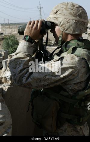 22. November 2004; Fallujah, Irak; 2. Lieutenant ERIC M. WILLIAMS, der Vorwärtsbeobachter für Battery S, 5. Bataillon, 7. Marineregiment Observer trifft Downrange durch Ferngläser. Die Leitung von Artillerie-Feuer und Luftangriffen war die Mission von vier Marines, die der Kompanie A, 1. Bataillon, 8. Marine-Regiment-Feuerunterstützung zugewiesen wurden. Das Faustteam war für die Räumung stark befestigter Gebiete und für den Umgang mit schwer zu beseitigenden Teilen der Stadt verantwortlich. Stockfoto