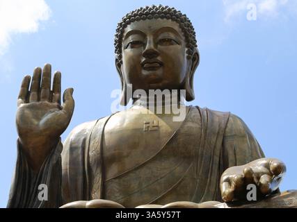 Nahaufnahme des Gesichts und der Hände des Tian Tan Buddhas in Meditationsposition auf Lantau Island (Hongkong) - 13. September 2024 Stockfoto