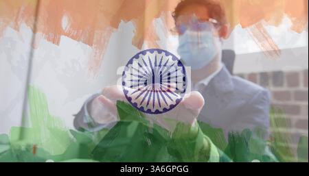 Zusammensetzung eines Geschäftsmannes mit Gesichtsmaske, der seine Hände im Amt über indischer Flagge desinfiziert. Globale Coronavirus-Pandemie und indisches Gesundheitswesen cris Stockfoto