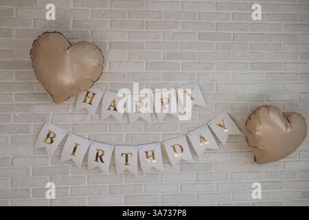 Happy Birthday Steine über zwei Holzstücken mit Grashintergrund Stockfoto