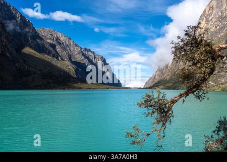 Ein atemberaubender türkisfarbener See reflektiert den blauen Himmel, eingebettet zwischen hoch aufragenden Bergen. Die friedliche Landschaft ist Teil der berühmten Laguna 69 Trek in Hu Stockfoto