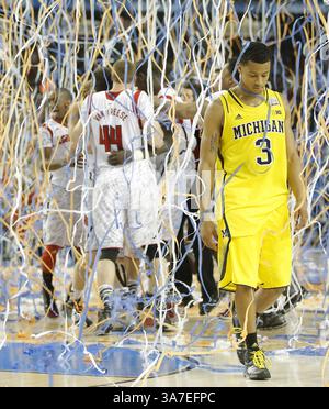 8. April 2013 - Atlanta, GA, USA - Trey Burke (3) von den Michigan Wolverines verlässt das Spielfeld, während Spieler aus Louisville am Montag, 8. April 2013 im Georgia Dome in Atlanta, Georgia, einen Sieg bei der NCAA Men's Basketball Championship 82-76 feiern. (Kreditbild: © Travis Heying/MCT/ZUMAPRESS.com) Stockfoto