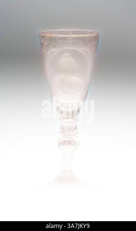 Ein elegant gefertigter Becher mit komplizierten Designs zeigt ein zartes Profilrelief einer Figur, umgeben von kunstvollen Details, die von einem schlanken, anmutig geformten Stiel getragen werden. Die gesamte Ästhetik unterstreicht die Handwerkskunst und die Kunstfertigkeit, die bei der Entstehung der Kunst zum Einsatz kommt., Klassische Kunst mit modernem Twist neu interpretiert von Artotop, Goblet, Mitte des 18. Jahrhunderts, Deutschland, Sachsen, Sachsen, Glas, H 23,9 cm (3/8 Zoll) Stockfoto