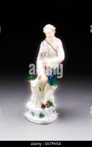 Eine zarte Porzellanfigur zeigt eine elegant gekleidete junge Frau, die einen Blumenstrauß hält, begleitet von einem verspielten Hund zu ihren Füßen, der einen ruhigen und nostalgischen Charme verkörpert., Klassische Kunst mit modernem Twist von Artotop, Figur eines Mannes und Hundes, Ende des 18. Jahrhunderts, Deutschland, Hartporzellan mit polychromer Emaildekor, H. 24,1 cm (9 1/2 Zoll) Stockfoto