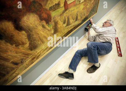 27. März 2013 – West Bend, WI, USA – August Peter arbeitet daran, einem Gemälde von John Steuart Curry Oil on Canvas, das vom Chazen Museum in der UW Madison geliehen wurde, den letzten Schliff zu verleihen. Die Arbeiten wurden am 27. März 2013 im Museum of Wisconsin Art in West Bend an der Veterans Avenue durchgeführt. (Bild: © Mike de Sisti/MCT/ZUMAPRESS.com) Stockfoto