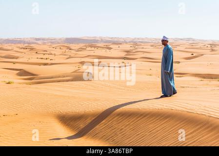 Mann steht auf einer Düne in Wahiba Sands (Sharqiya Sands), Wüstenregion im Sultanat Oman Stockfoto