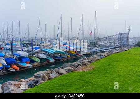 Oceanside, Kalifornien - 3. Januar 2025: Ruhige Szene eines nebeligen morgens in der Oceanside Marina, mit farbenfrohen Kajaks entlang der Anlegestelle mit s Stockfoto