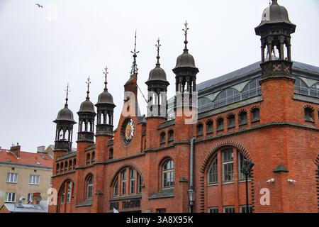 Danzig, Polen - 11.11.2024: Die historische Markthalle (Hala Targowa) in Gdańsk, ein Wahrzeichen für Shopping und lokale Produkte im Winter. Stockfoto