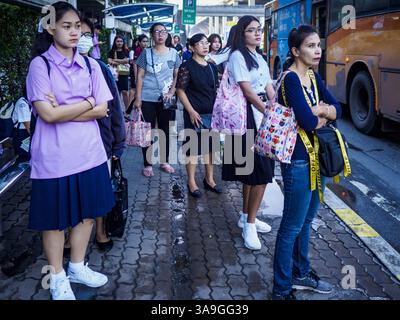 25. September 2017 - Rangsit, Pathum Thani, Thailand - Passagiere warten an einer Transitstation in der Nähe der Future Park Mall in Rangsit, Provinz Pathum Thani, etwa eine Stunde nördlich von Bangkok, an Bord von Bussen nach Bangkok. Einst eine ruhige Provinz im Reisanbaugebiet Zentralthailands, ist Pathum Thani, insbesondere Rangsit, die südlichste Stadt der Provinz, zu einem Vorort von Bangkok geworden. Zehntausende von Menschen nutzen die Bus- und Kleinbushaltestellen, um zu den Stadtbahnstationen in Bangkok zu gelangen und dann zur Arbeit zu gehen. Hunderte weitere fahren mit den State Railways of Thailand Pendlerzügen, die von den nördlichen Vororten nach Thailand fahren Stockfoto