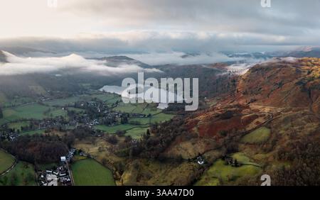 Aerial panorama landscape view of the lakeside village of Grasmere and lake in The English Lake District National Park with surrounding mountains and Stockfoto