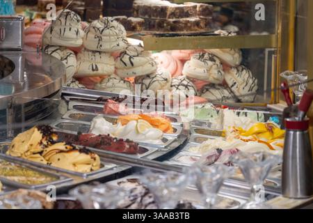 Desserts und Eis in einem Geschäft in Italien. Es gibt viele verschiedene Geschmacksrichtungen und Arten von Desserts, einschließlich Kuchen, Gebäck und Eis cr Stockfoto