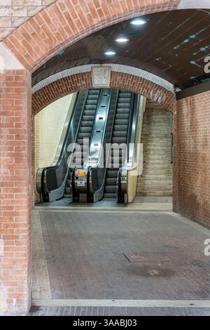 Eine lange Rolltreppe befindet sich in einem Tunnel mit einer Ziegelmauer in Perugia Italien Umbrien. Es gibt zwei Rolltreppen, eine links und eine rechts Stockfoto