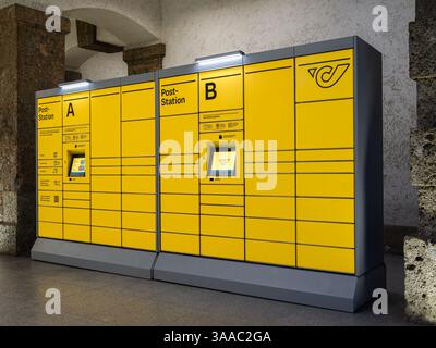 Innsbruck, Österreich - 20. März 2025: Gelbe Postfächer der Österreichischen Post in Innsbruck mit digitalen Bildschirmen im öffentlichen Bereich Stockfoto