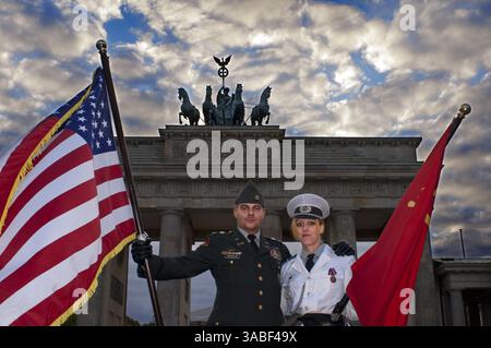 29. September 2010 - Berlin, Berlin, Deutschland - Schauspieler, die als amerikanische und sowjetische Soldaten gekleidet sind, posieren für Fotos mit Touristen vor dem Brandenburger Tor in Berlin, einem der berühmtesten Wahrzeichen des Kalten Krieges. Das Brandenburger Tor ist das Markenzeichen von Berlin. Der Haupteingang der Stadt, der dreißig Jahre lang von der Mauer umgeben war, war in der ganzen Welt als Symbol für die Teilung der Stadt und für die Teilung der Welt in zwei Machtblöcke bekannt. Heute kommen internationale Besucher auf dem Pariser Platz, um dieses erste Tor zur Stadt wieder zu erleben und die lang verstrichene Freiheit zu genießen Stockfoto