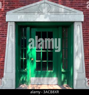 Eine grüne Tür mit einem neoklassizistischen Steingiebel und einer roten Ziegelfassade. Stockfoto