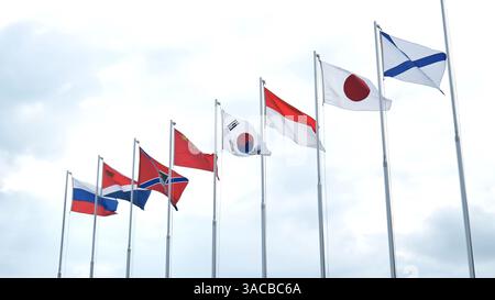 Nationale Flaggen flattern vor trübem Hintergrund, die globale Konnektivität und diplomatische Beziehungen repräsentieren Stockfoto